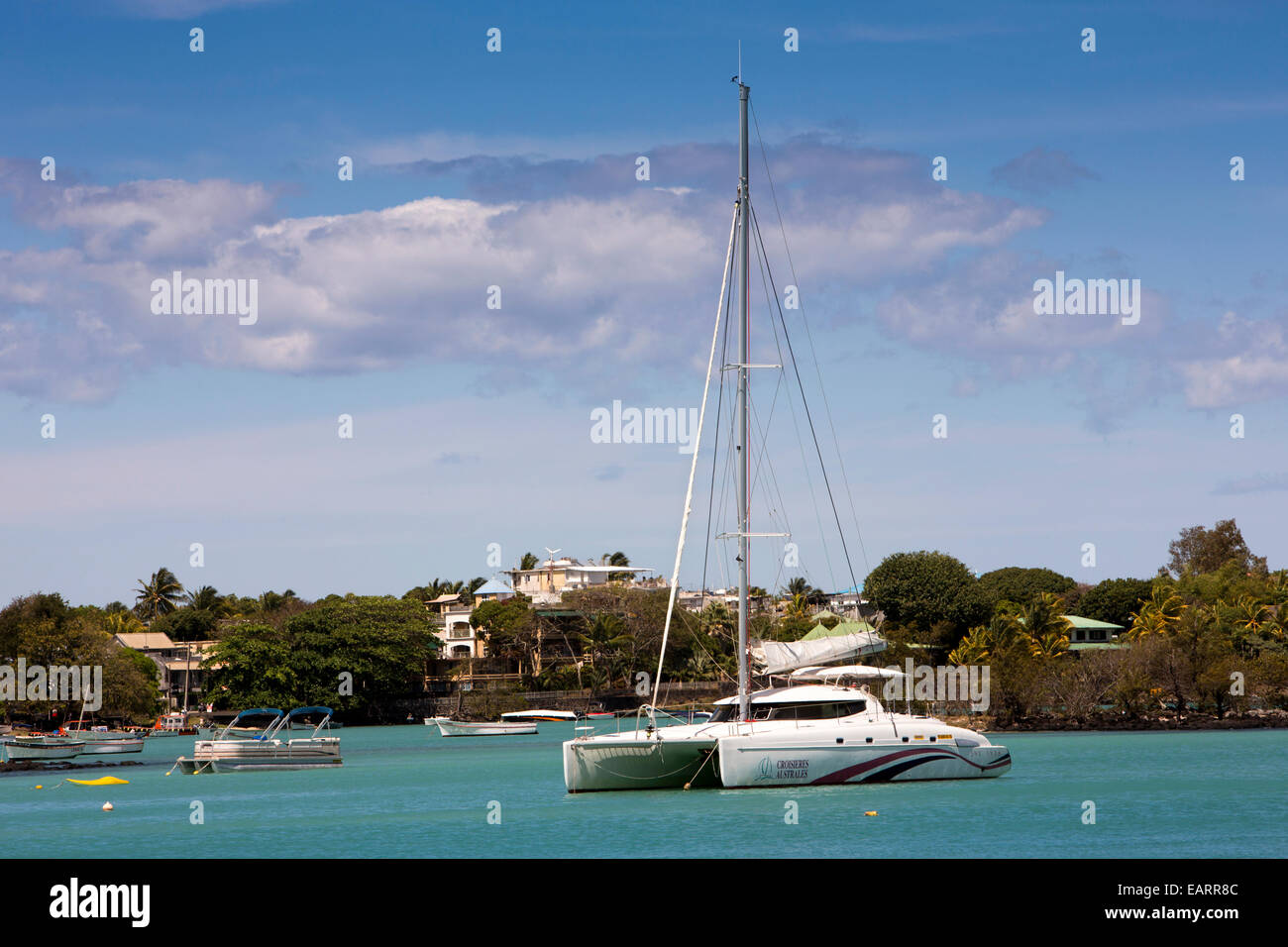 Mauritius, Grand Baie, public beach, sailing catamaran moored in sheltered bay Stock Photo