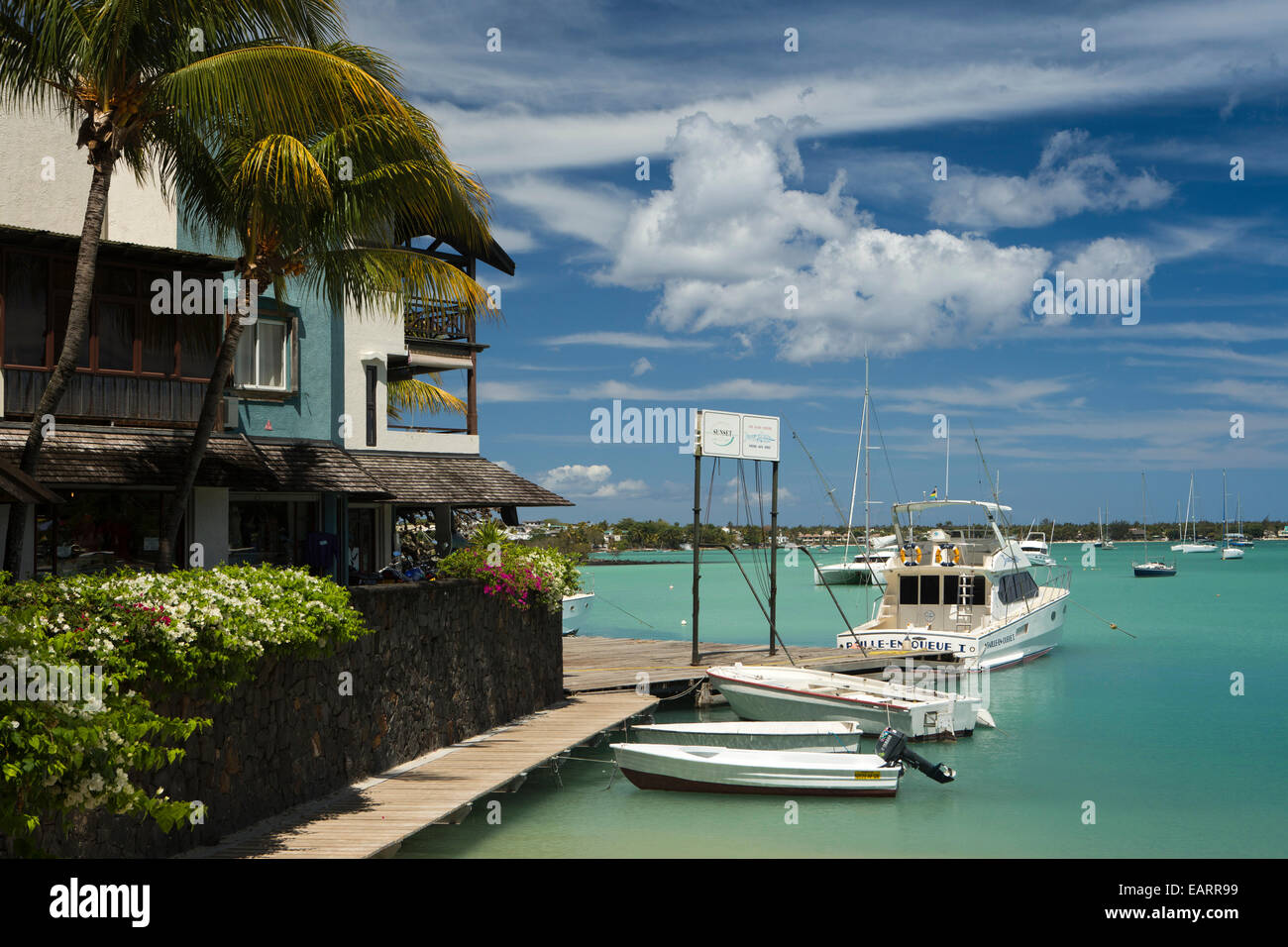 Mauritius, Grand Baie, public beach, fishing boats moored at jetty Stock Photo