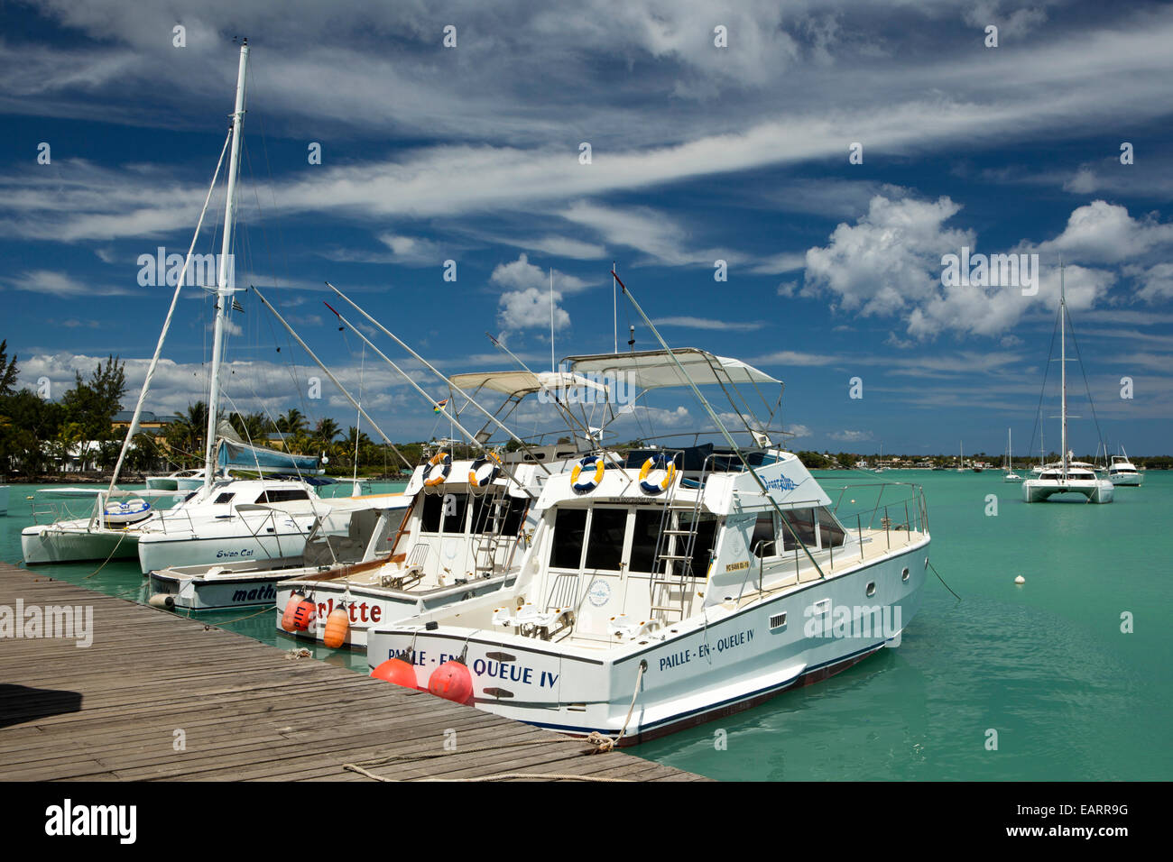 Mauritius, Grand Baie, public beach, big game fishing boats moored at jetty Stock Photo