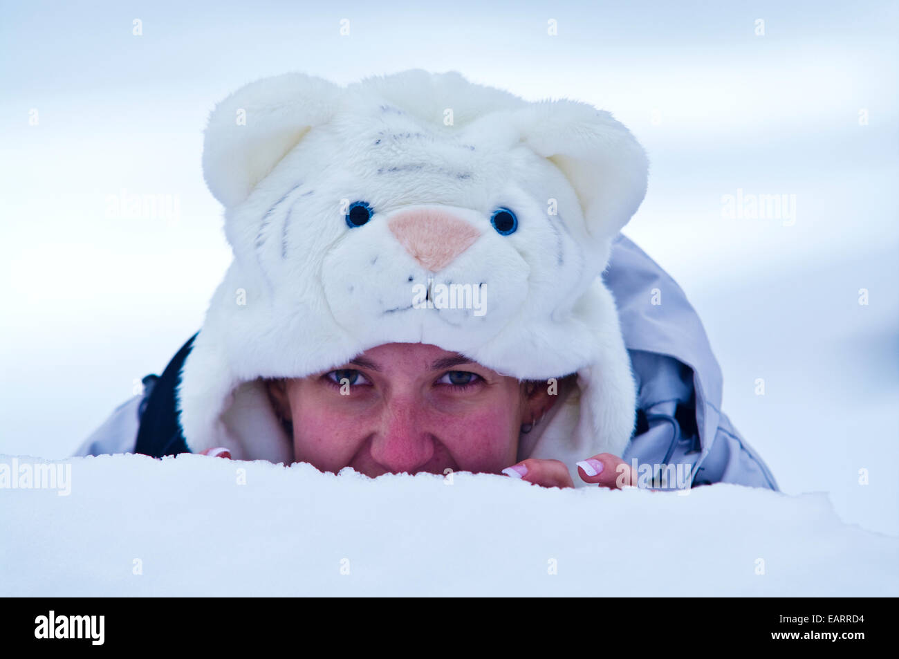 A prowling tourist in a fluffy white tiger hat to keep her head warm. Stock Photo