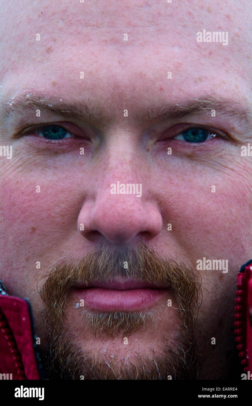 A tourist's intense stare as he exhales steam from his nostrils. Stock Photo