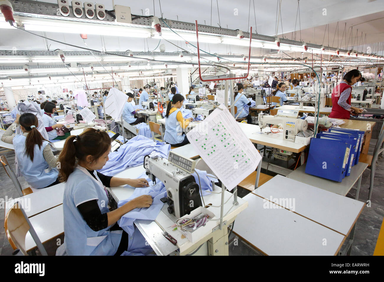 Hanoi, Vietnam. 20th Nov, 2014. Workers sit at sewing machines in a