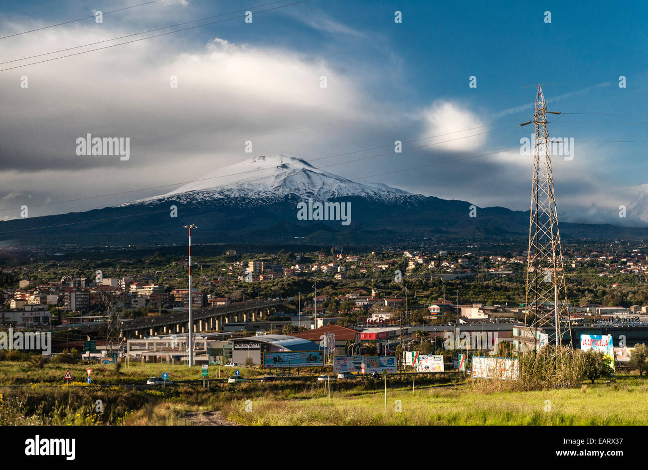 Sicily, Italy. The snow-capped volcano of Mount Etna (3357m) towers over the city of Catania Stock Photo