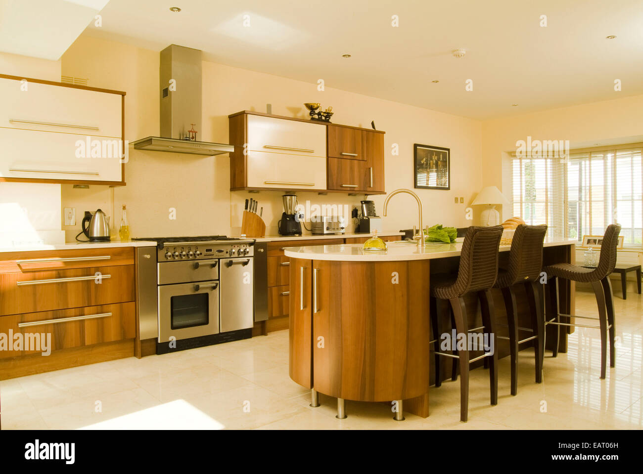 Spacious modern kitchen with central island breakfast bar and range