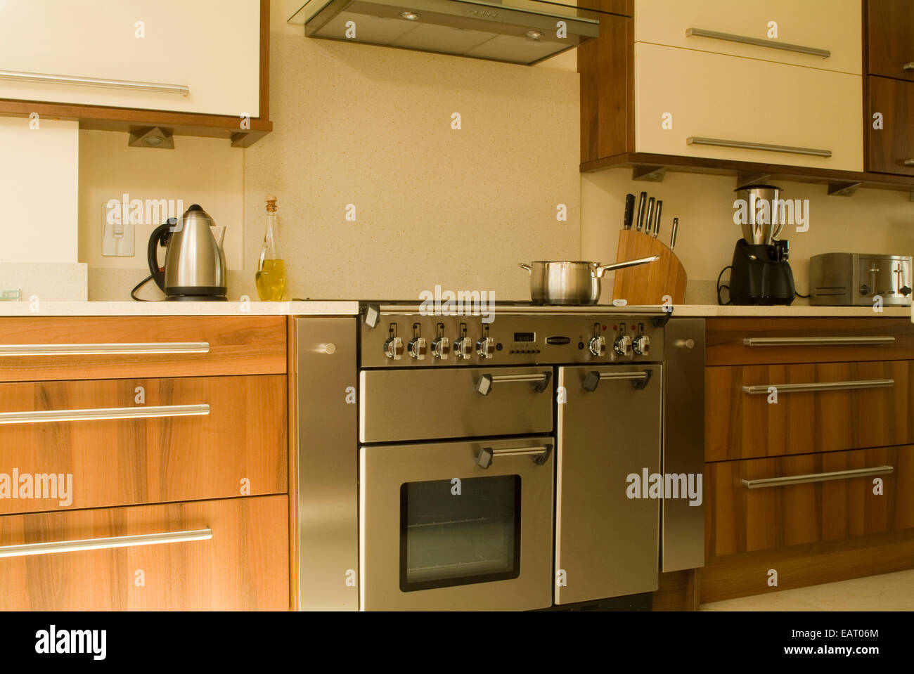 Modern kitchen with wooden units and range oven Stock Photo - Alamy