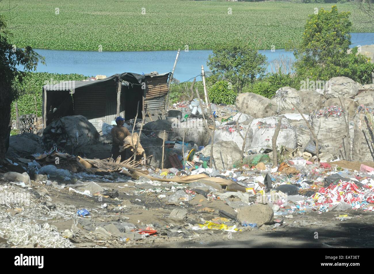 A city dump contrasts greatly with Lake Managua in the background Stock