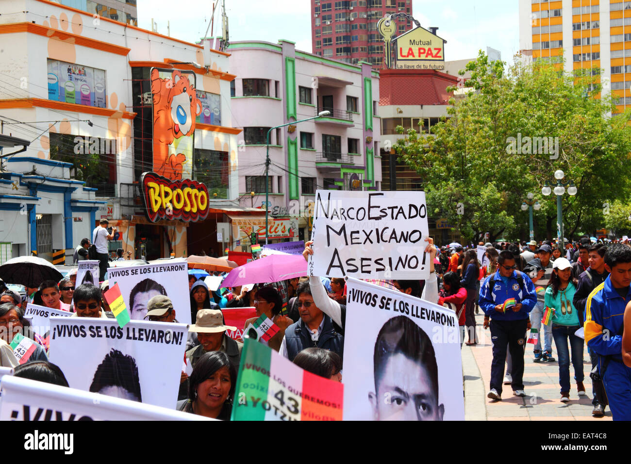 La Paz, Bolivia. 20th November, 2014. Protesters march to demand justice for the 43 missing students in Mexico and protest against the Mexican government's handling of the case and corruption. One placard accuses the Mexican government of being a narco state. Today has been designated a Global Day of Action for Ayotzinapa; a national strike is planned in Mexico and many protests are taking place worldwide. The students (who were from a teacher training college) disappeared after clashing with police on the night of 26th September in the town of Iguala. Credit:  James Brunker / Alamy Live News Stock Photo