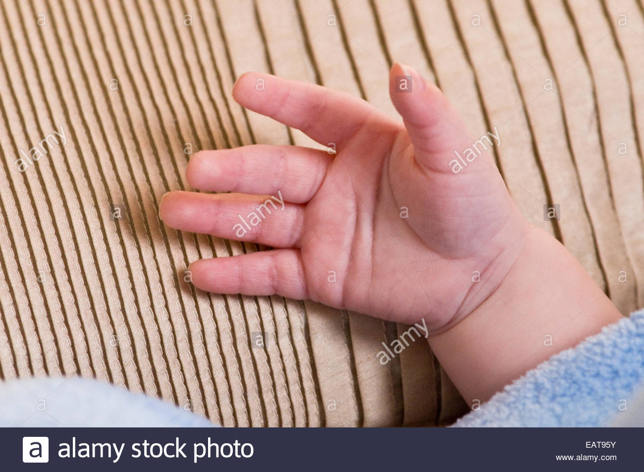 A Four Month Old Baby Places A Hand On A Pillow Stock Photo