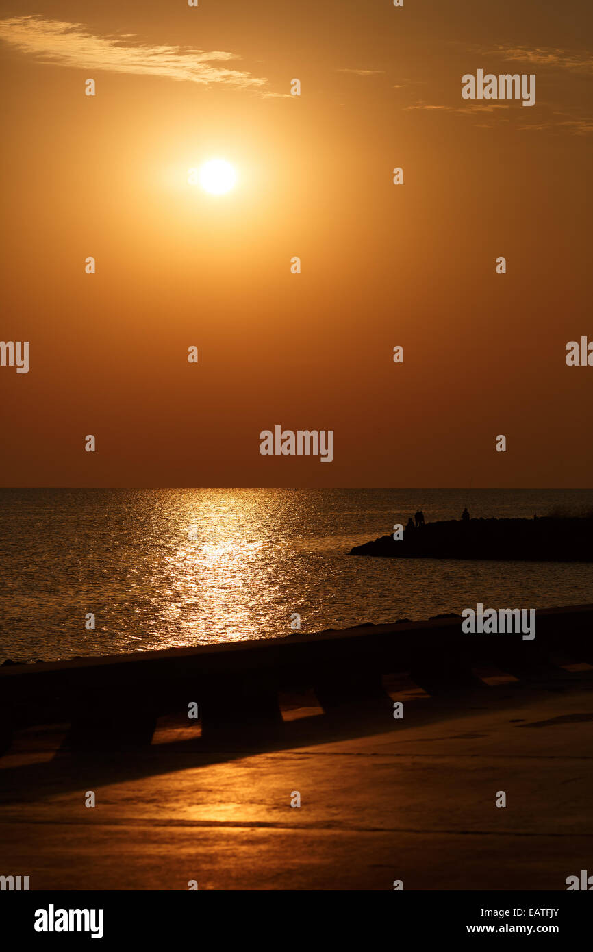 Orange sunrise over the sea. Vertical shot Stock Photo - Alamy