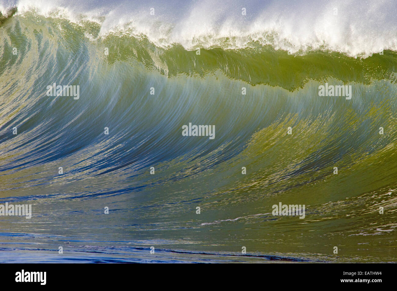 Detail of a wave breaking at sunrise in Ventura Harbor, California. Stock Photo