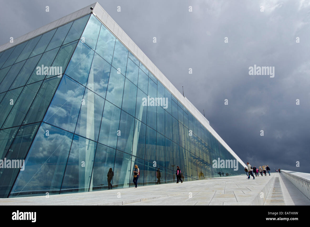 Tourists enjoying the exterior of the Den Norske Opera and Ballet House. Stock Photo