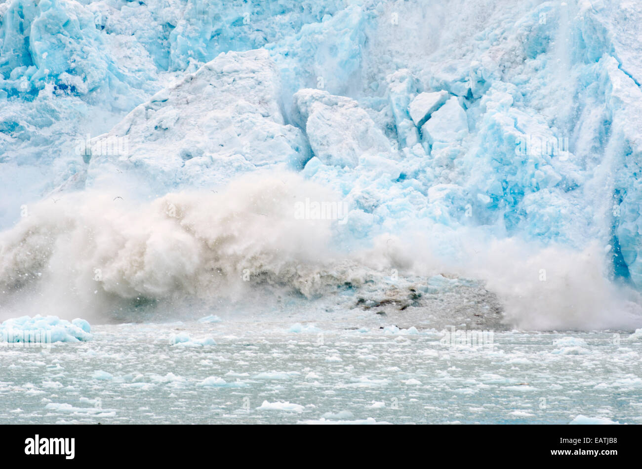A massive calving of ice into the ocean from Lillienhookbreen glacier. Stock Photo