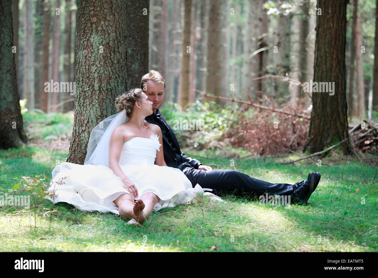 bride and groom shooting at the wedding in the forest Stock Photo
