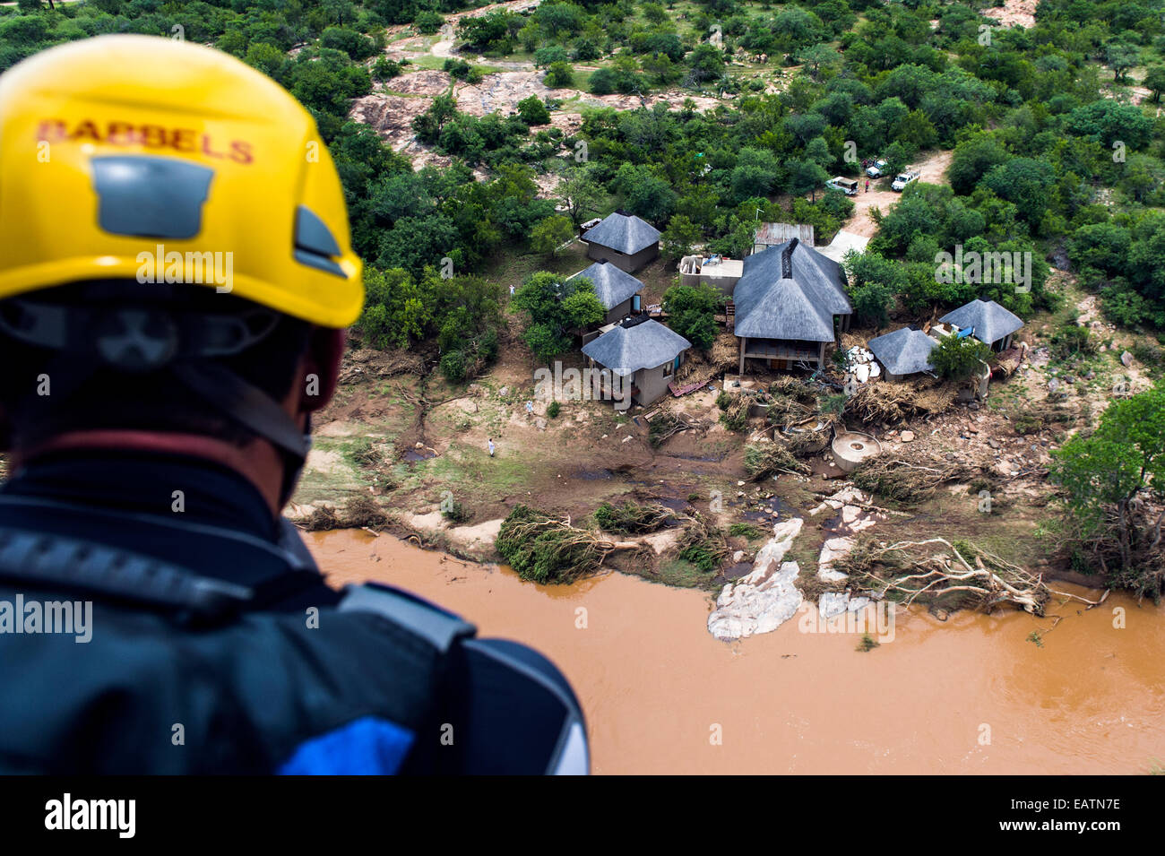 An airforce rescue crew surveys flood damage to a safari lodge. Stock Photo