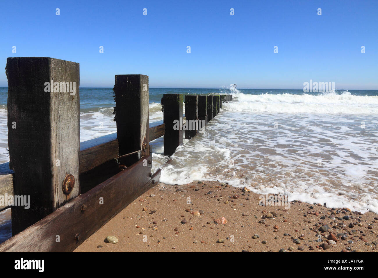 Waves rolling in from the North Sea onto the groynes at Aberdeen beach, Scotland Stock Photo