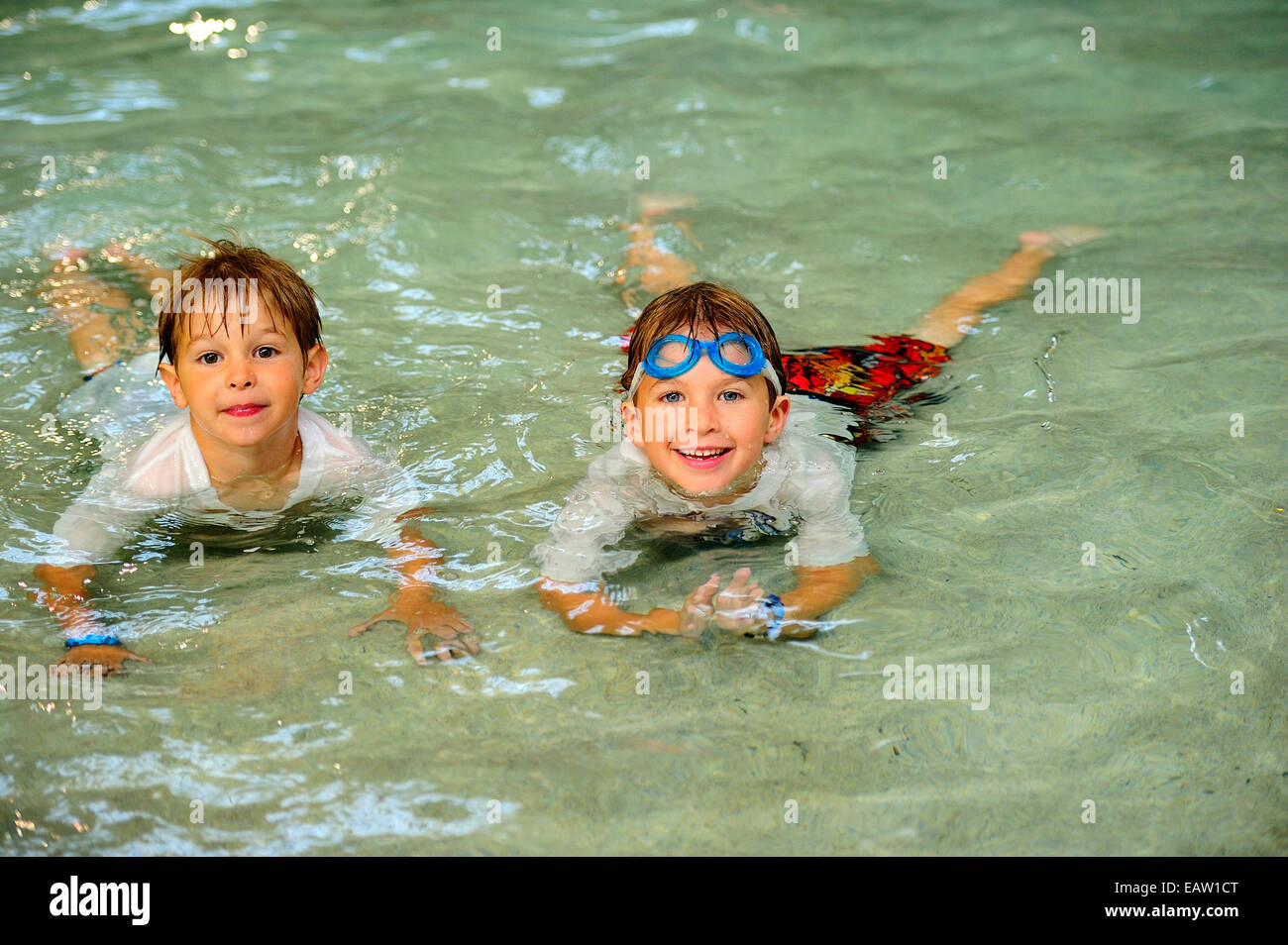 Two young boys having fun in a pool. Stock Photo