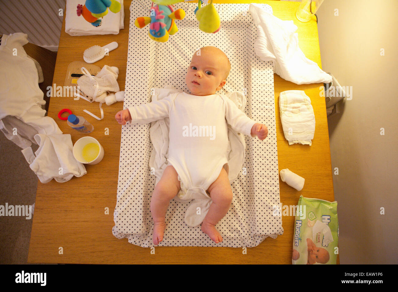 Baby laying on changing mat Stock Photo Alamy