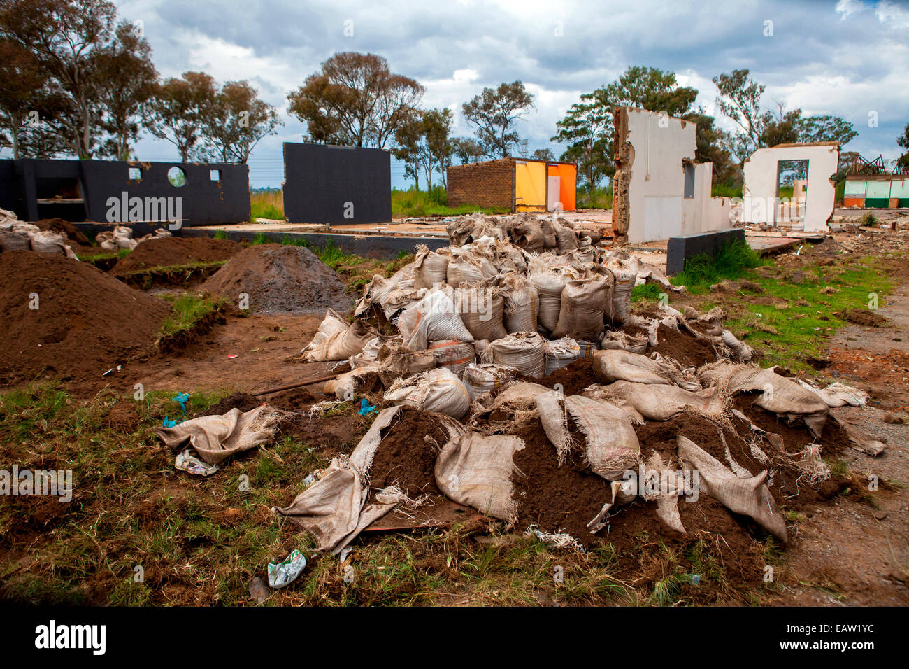 Bags of soil containing small amounts of gold sit slashed and abandoned after police forced illegal gold miners to destroy them Stock Photo