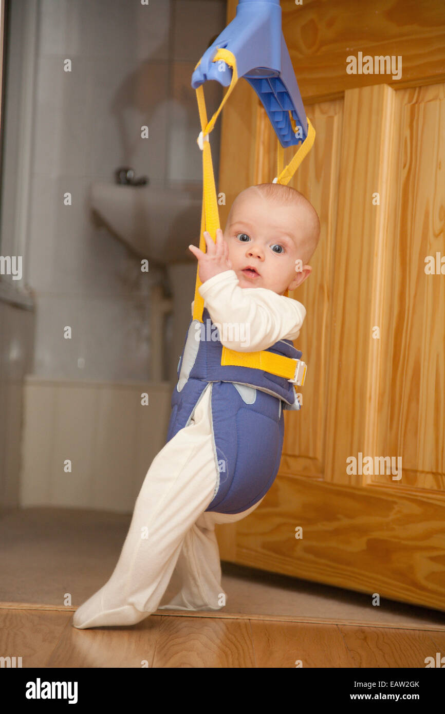 Baby in a door bouncer Stock Photo Alamy