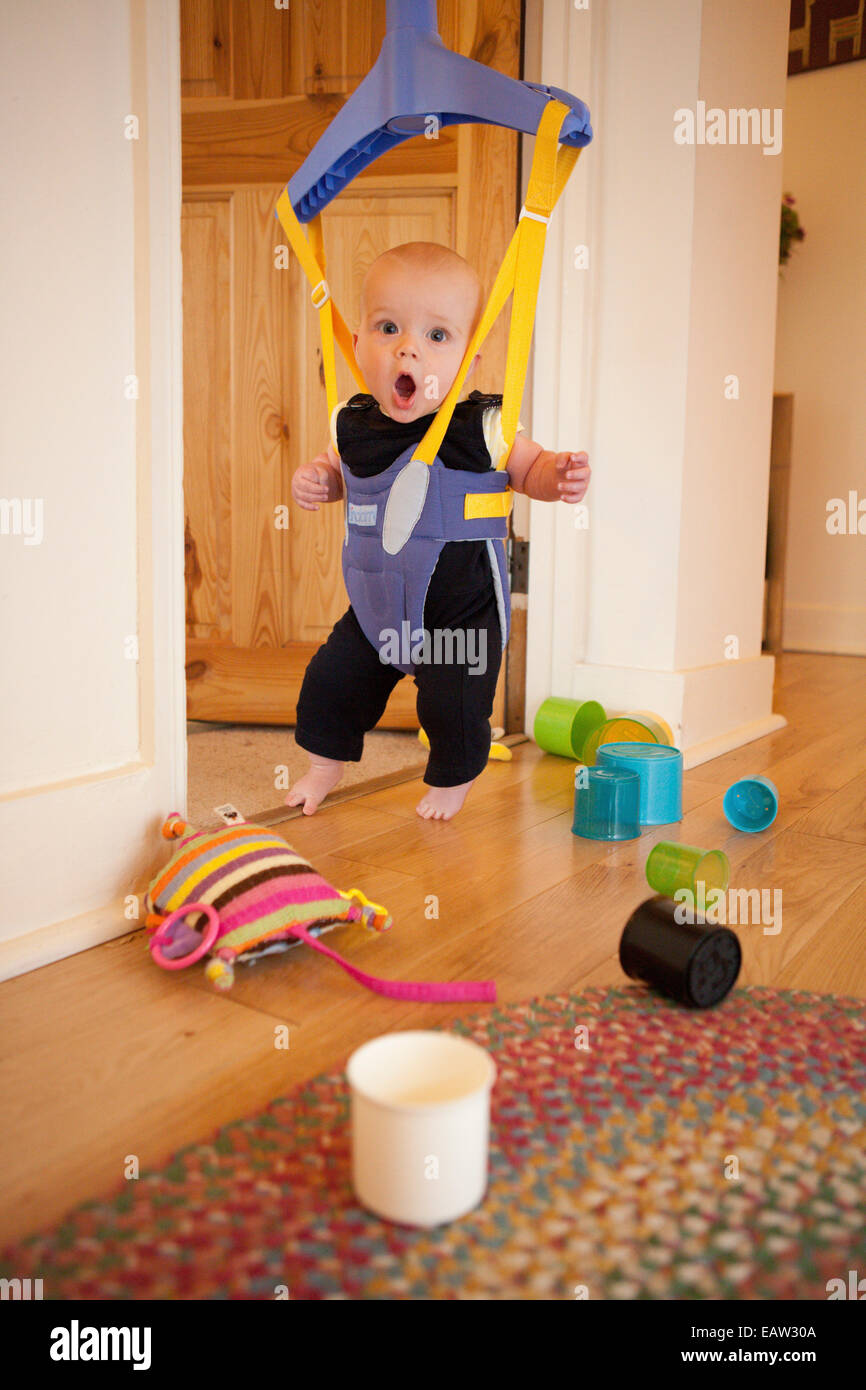 Baby in a door bouncer Stock Photo Alamy