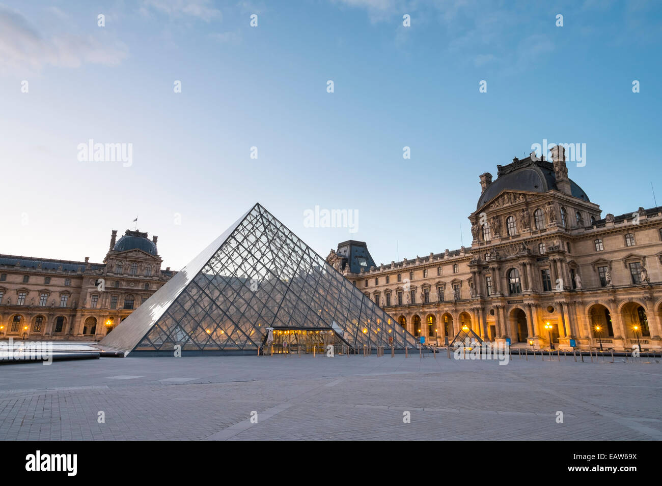 Courtyard and glass pyramid of the Louvre Museum at sunrise, Paris, √ésle-de-France, France Stock Photo