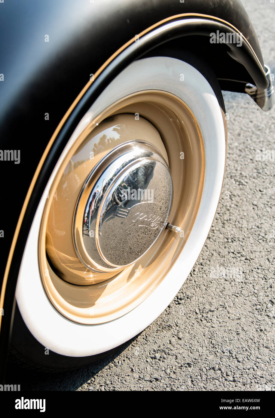 Whitewall tire of a custom Ford car at the Wheels and Waves custom motorbike festival in Biarritz, France. Stock Photo