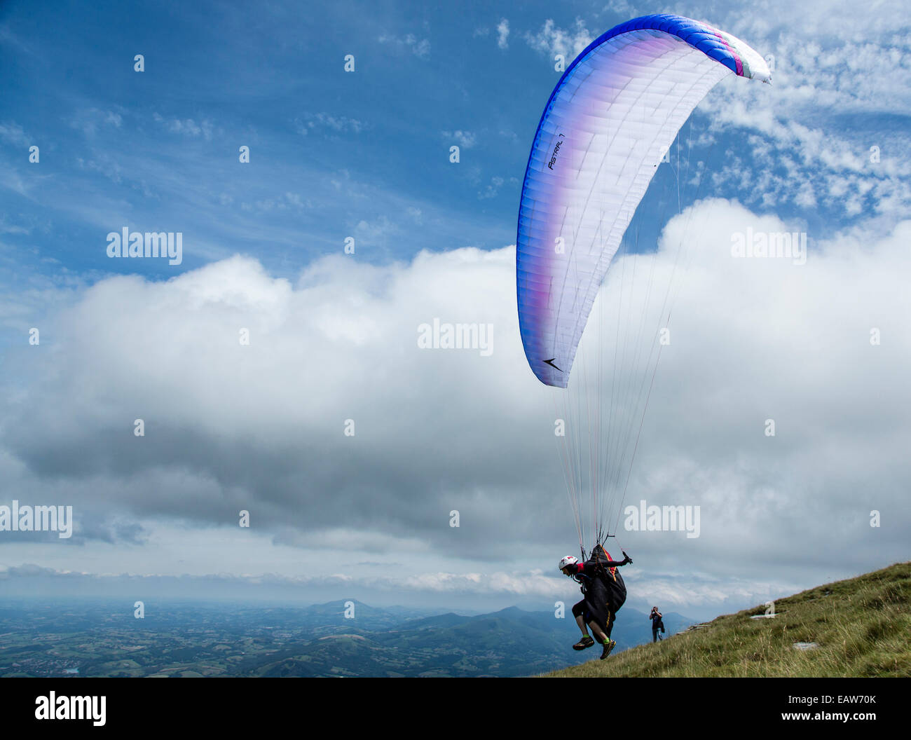 A pilot flying a paraglider at the second edition X-Pyr paraglading and hiking competition in Larun, Spain. The objective is to cross the Pyrenees,from west to east, starting at the Bay of Biscay and finishing by the Mediterranean. The first one to achiev Stock Photo
