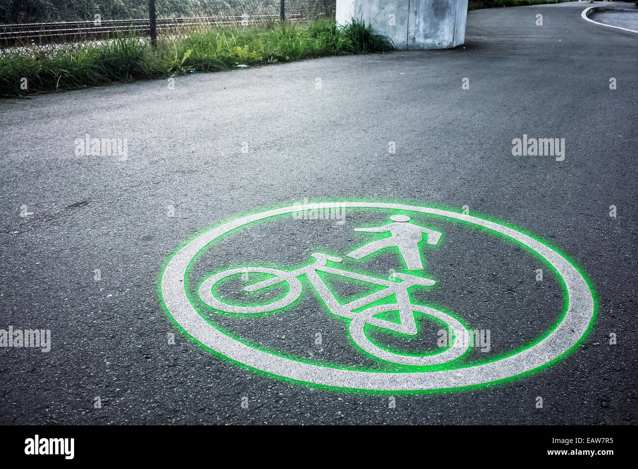 Green bicycle road circle sign symbol on a bike lanes ground asphalt, environment, nature, healthy, copy-space, copy space, Stock Photo