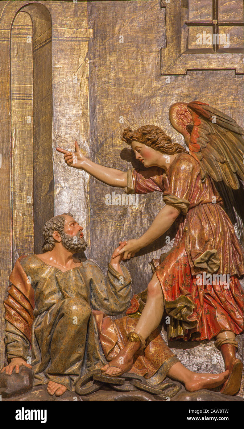 Seville - The carved polychrome relief of the scene Liberation Of Saint Peter on the main altar in church Iglesia de San Pedro Stock Photo