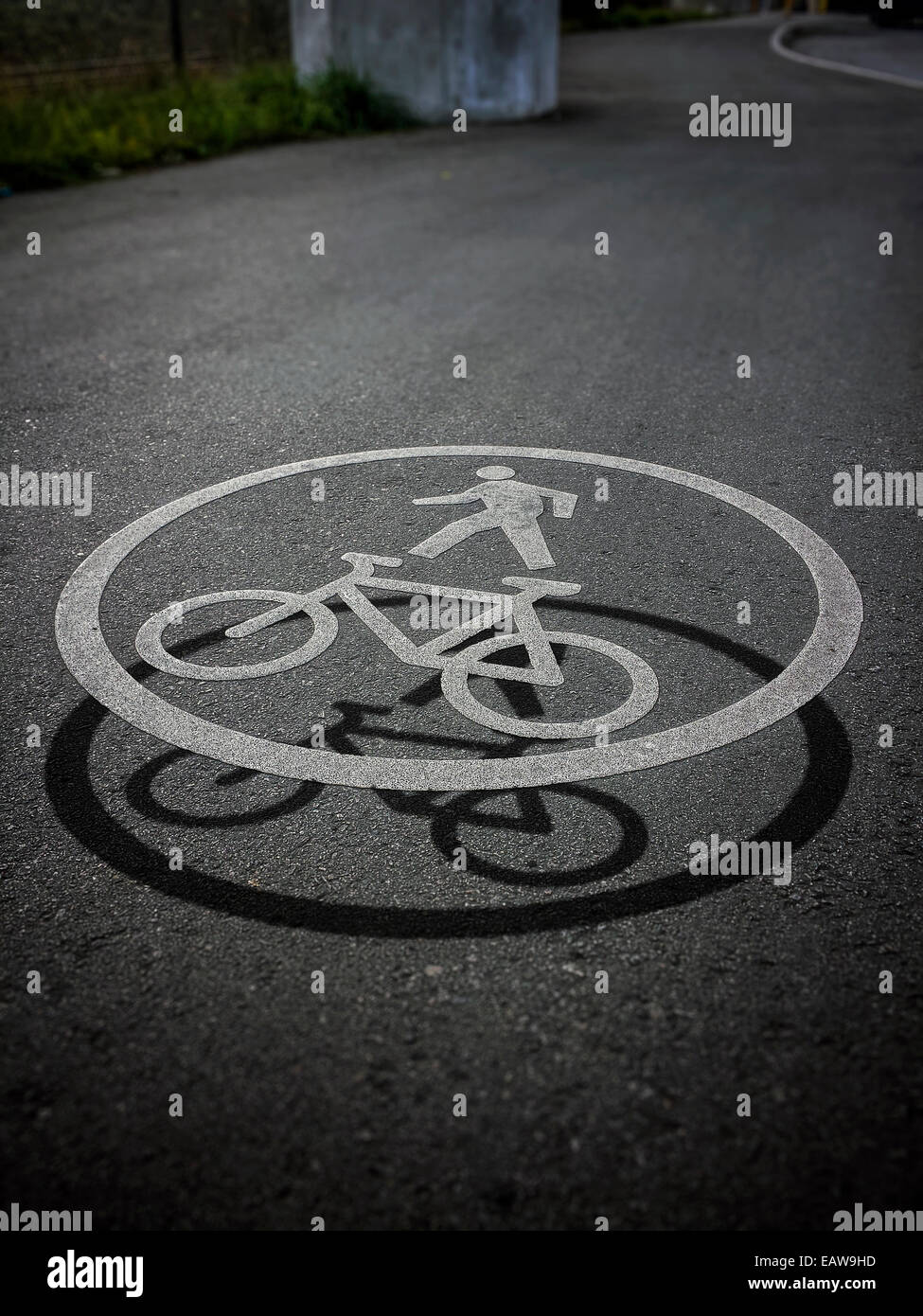 Cool effect white bicycle road circle sign symbol on bike lanes ground asphalt with a 3D effect shadow floating air, copy space Stock Photo
