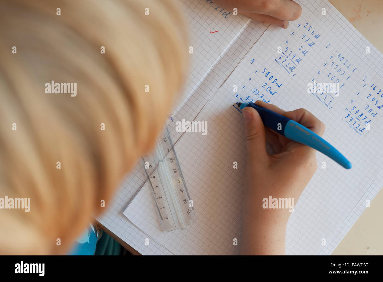 a 10-year old schoolchild is doing his math homework Stock Photo - Alamy