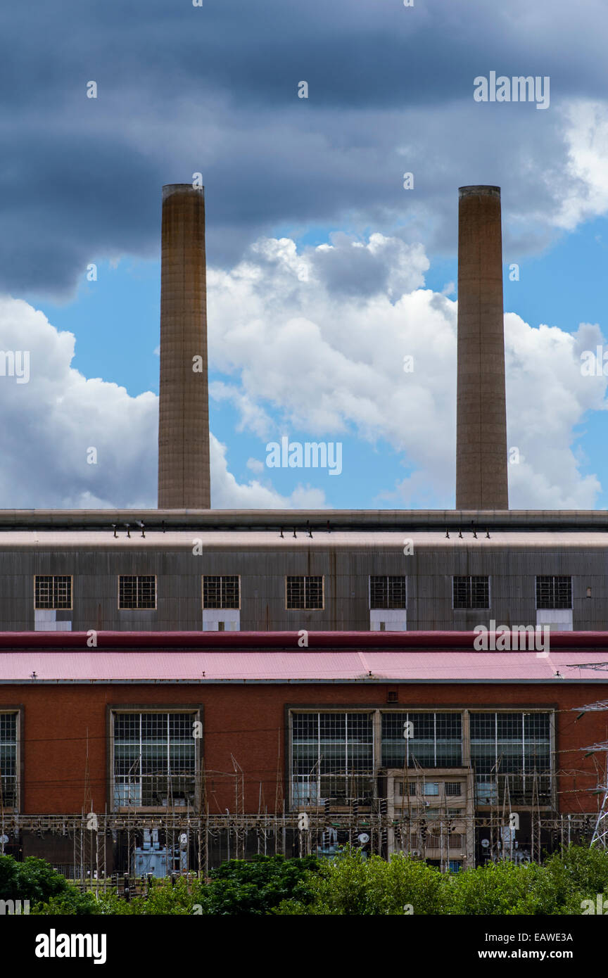 Chimneys rise from the ceiling of an electricity power station. Stock Photo