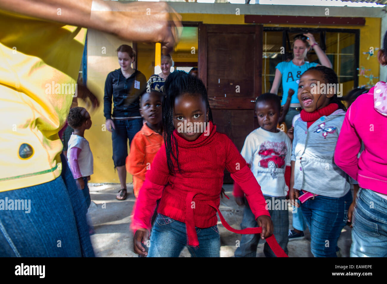Girls dance to African music during a break from classes at school. Stock Photo