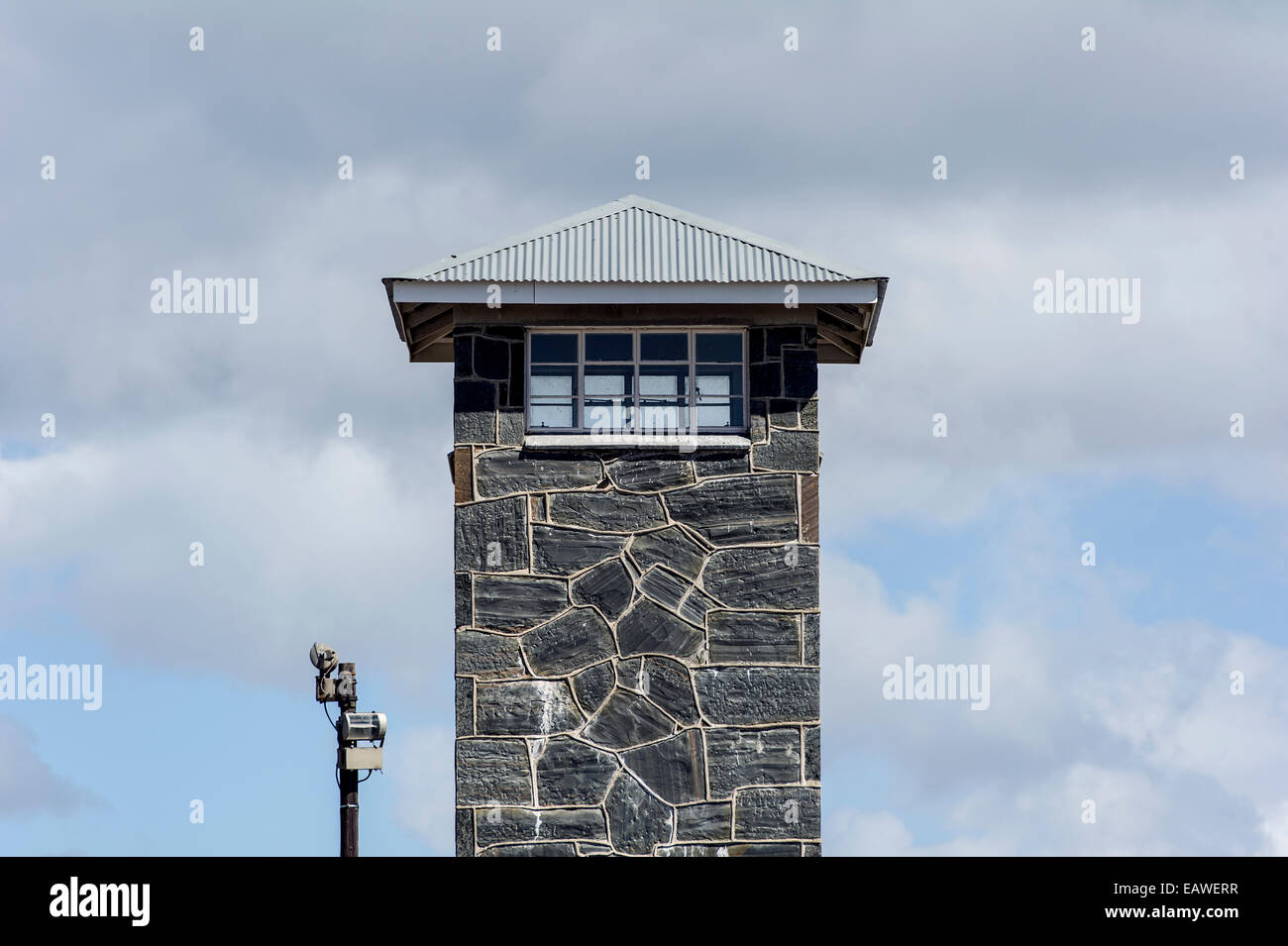 Windows of a guard post look out from a stone prison watch tower. Stock Photo