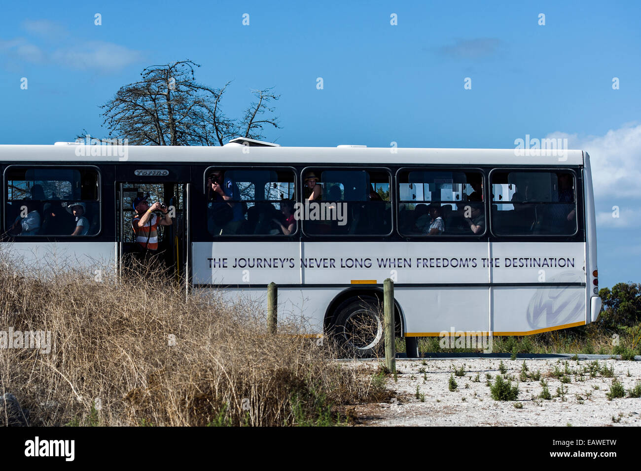 Tourists photograph a prison sulphur mine from a tour bus. Stock Photo