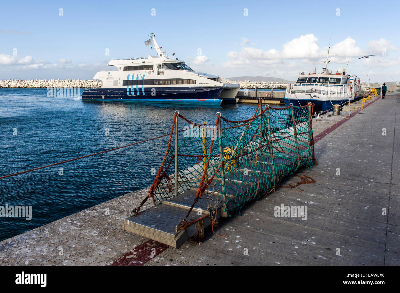 A gangplank rests on a ferry wharf waiting for disembarkation. Stock Photo