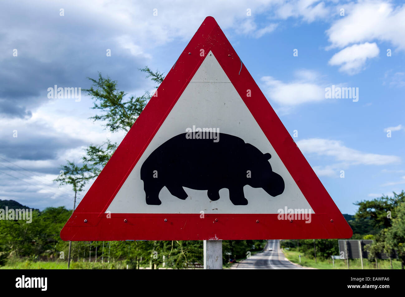 A sign warns motorists of Nile Hippopotamus crossing the road. Stock Photo