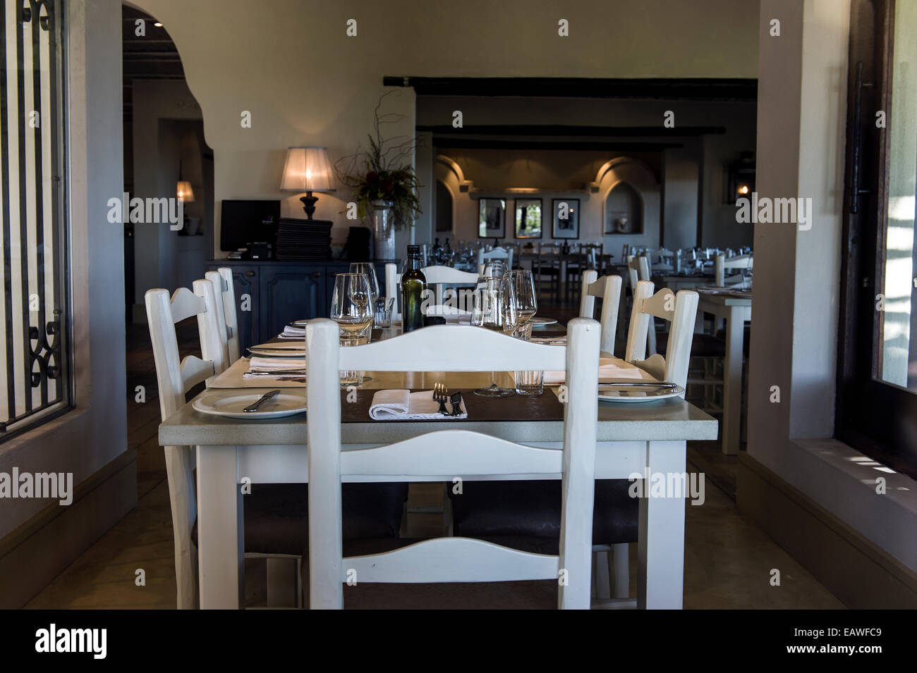 An elegant dining table set for a meal in a vineyard restaurant. Stock Photo