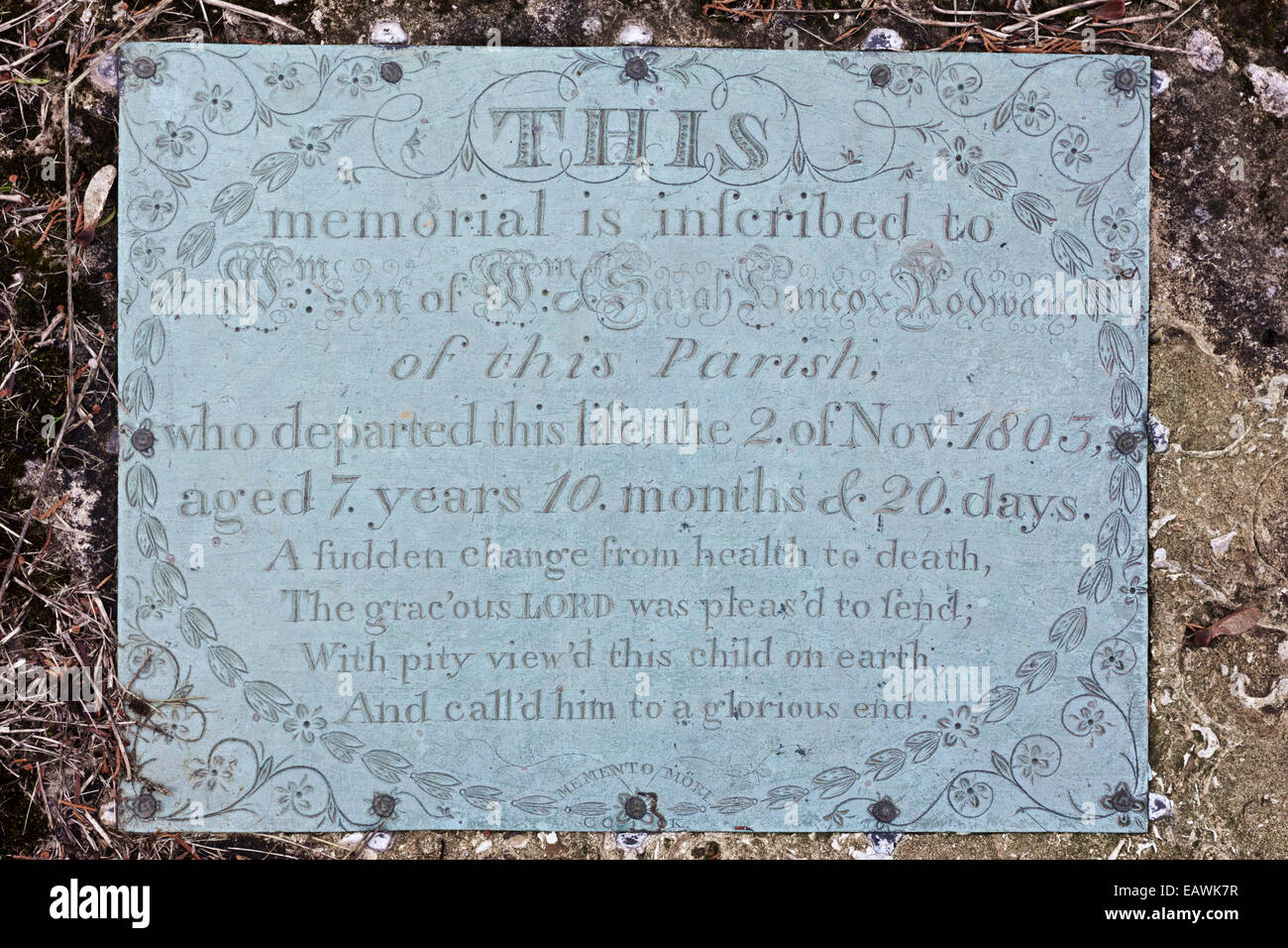 Brass plaque demonstrating infant mortality on a gravestone in the Cotswold village of Edgeworth, Gloucestershire UK Stock Photo