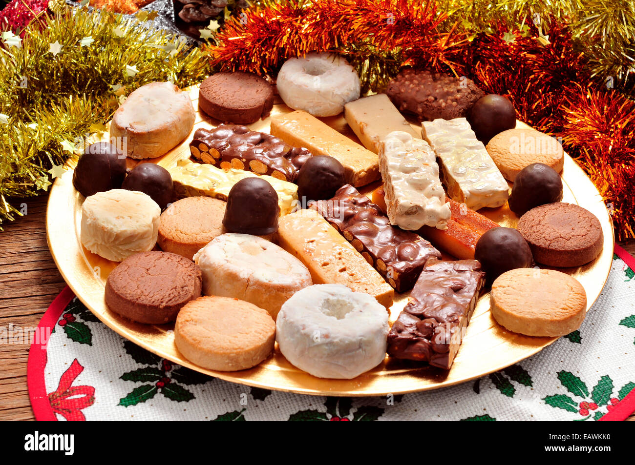 a tray with different turron, polvorones and mantecados, typical christmas confections in Spain, on an ornamented table Stock Photo