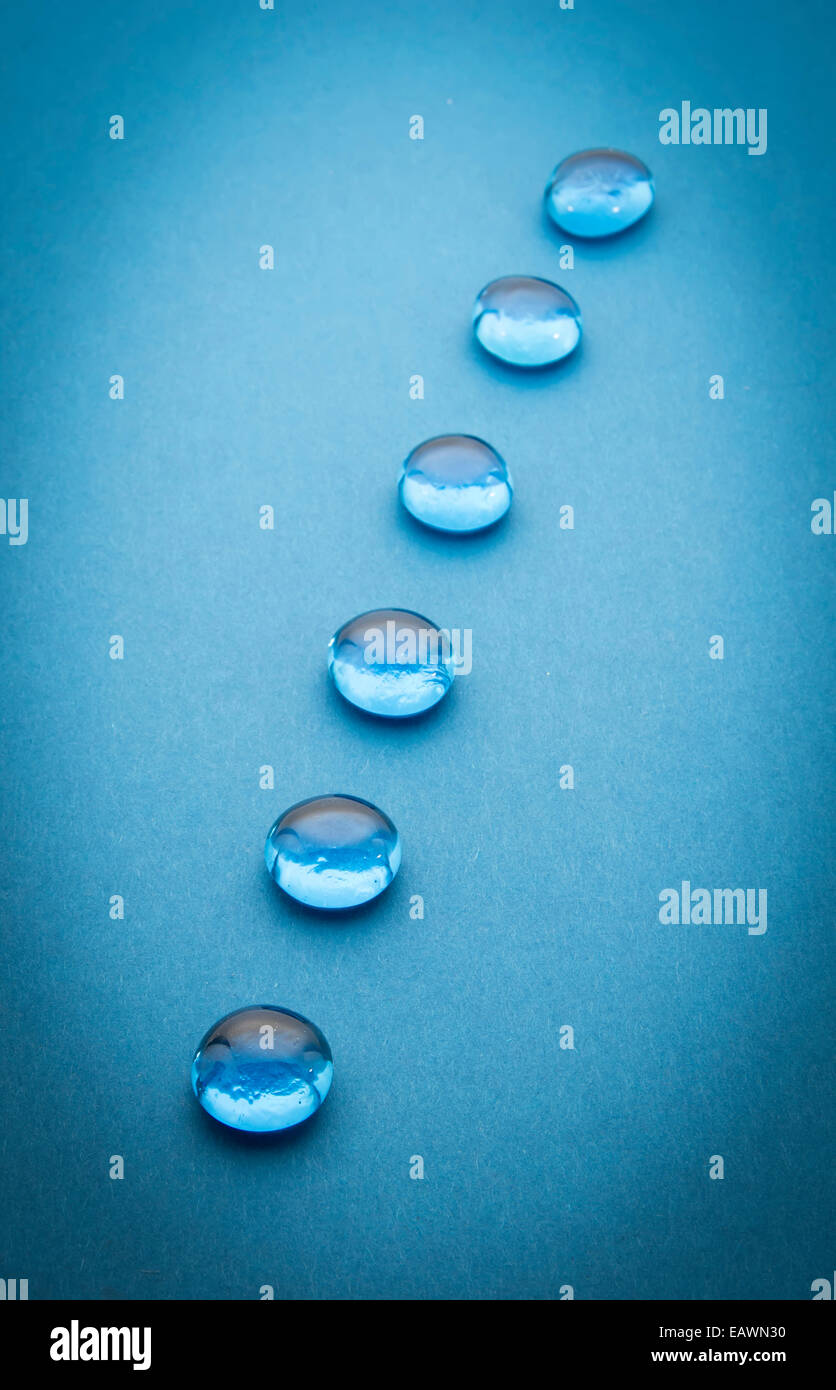 glass beads on blue background, selective focus Stock Photo