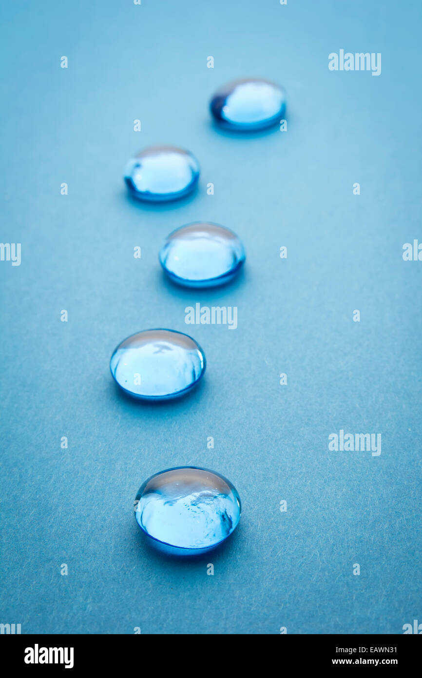 glass beads on blue background, selective focus Stock Photo