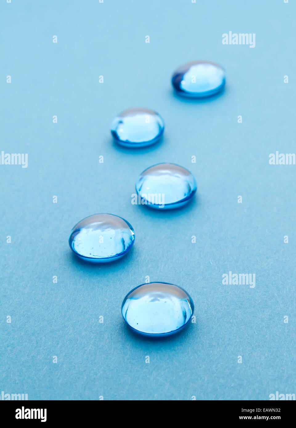 glass beads on blue background, selective focus Stock Photo