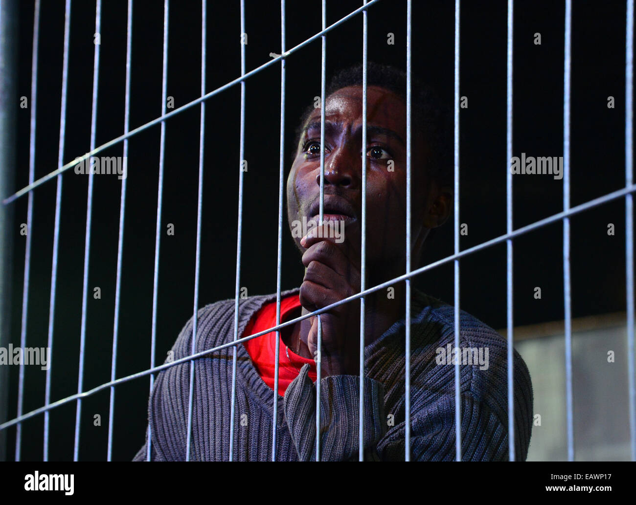 Altenburg, Germany. 19th Nov, 2014. Actor Moussa Ouedraogo of Burkina-Faso rehearses a scene of the play 'Die Schutzlosen. Les Zéros-Morts' (The Unprotected. The Dead Zeroes) at the Heizwerk (lit. heating station) stage at the theater in Altenburg, Germany, 19 November 2014. The play will premier on 22 November and focuses on European asylum policy. It was created in two languages as a co-production with the CITO theater of Ouagadougou, Burkina-Faso, where it will premier in January. The federal cultural fund supported the play with 123,000 euro. Photo: Martin Schutt/dpa/Alamy Live News Stock Photo