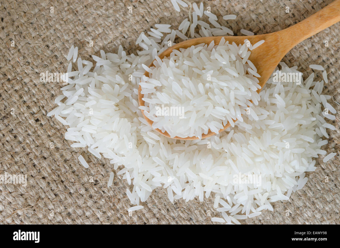 white rice grains with wooden spoon on sackcloth Stock Photo Alamy