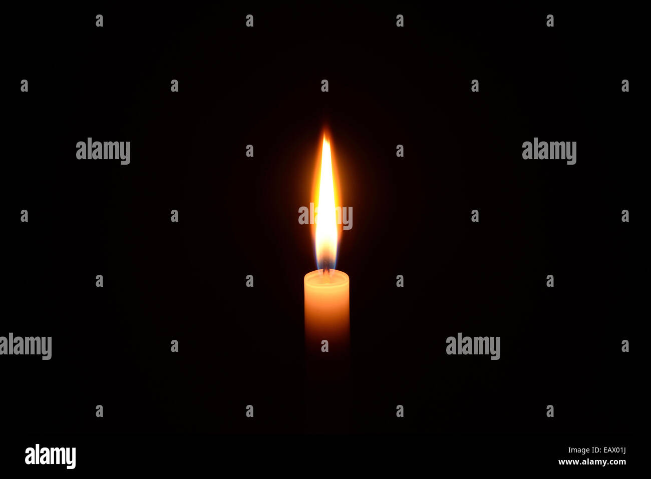 White candle burning on a black background Stock Photo - Alamy