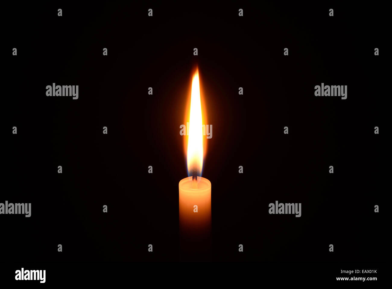 White candle burning on a black background Stock Photo Alamy