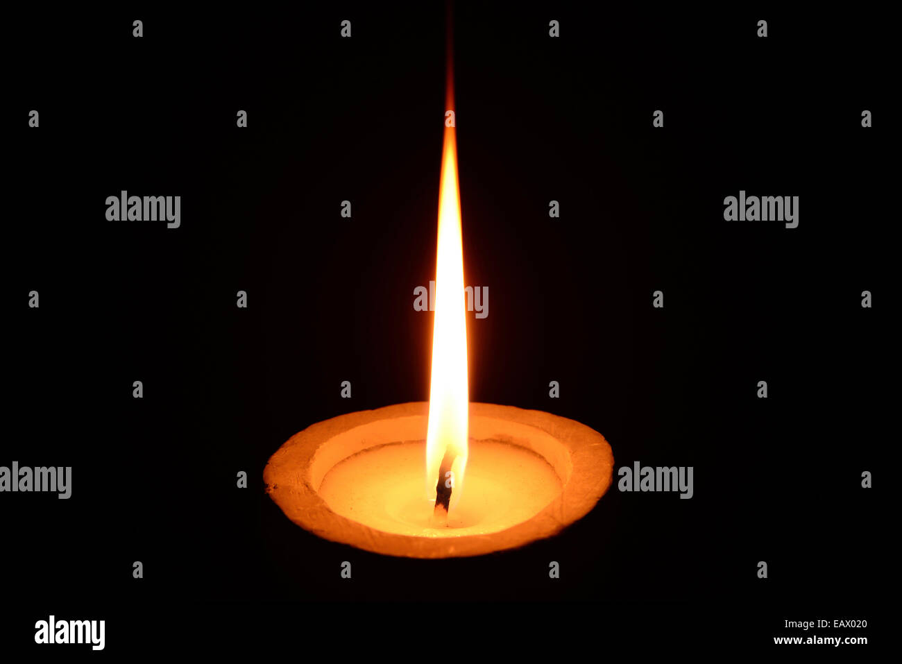 White candle burning on a black background Stock Photo Alamy
