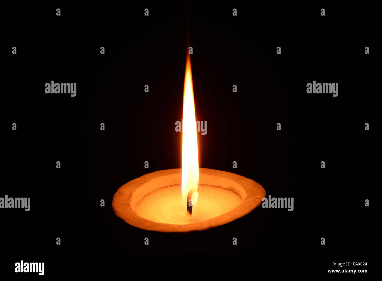 White candle burning on a black background Stock Photo Alamy