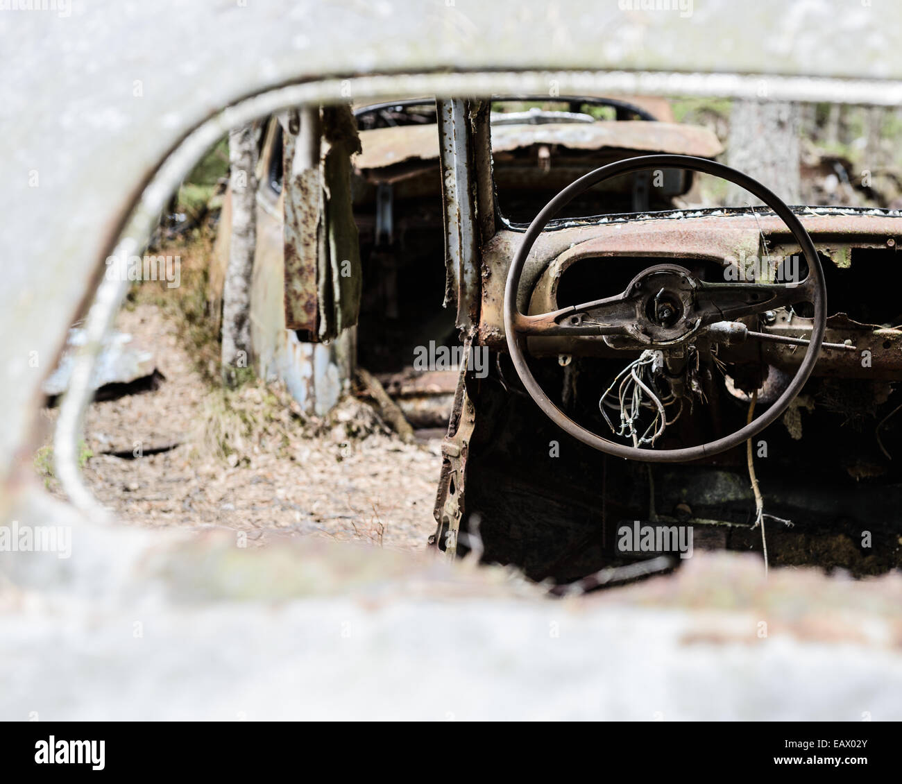 Broken steering wheel of a car seen through a side mirror Stock Photo
